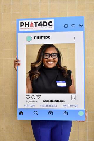 student holding phit placecard