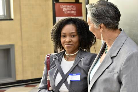 student smiling with woman