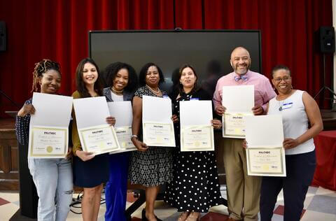 students posing with certificates