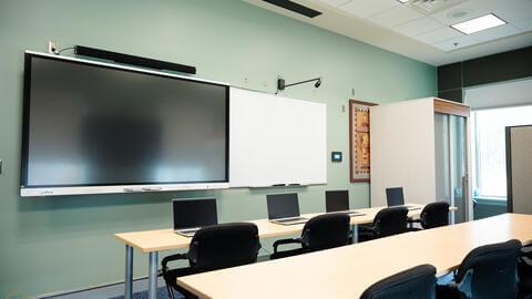 classroom with screen and whiteboard 